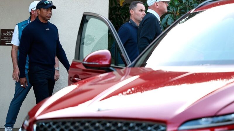 Tiger Woods leaves from the clubhouse after withdrawing from the tournament due to illness during the second round of