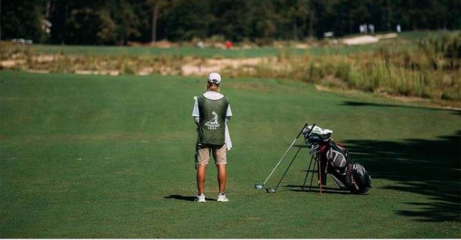 Pinehurst caddie gathering information before the next shot