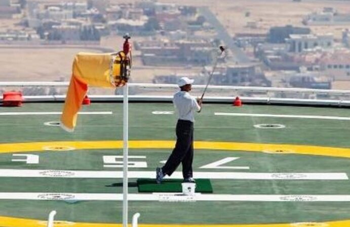 The American golfer Tiger Woods hits a few shots from the helicopter pad